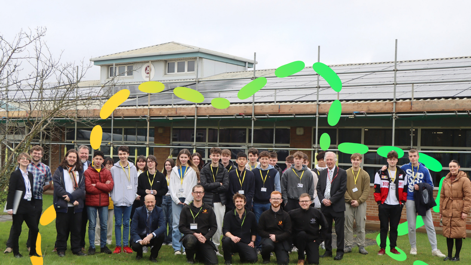 Students in front of their school during solar panel installation works.