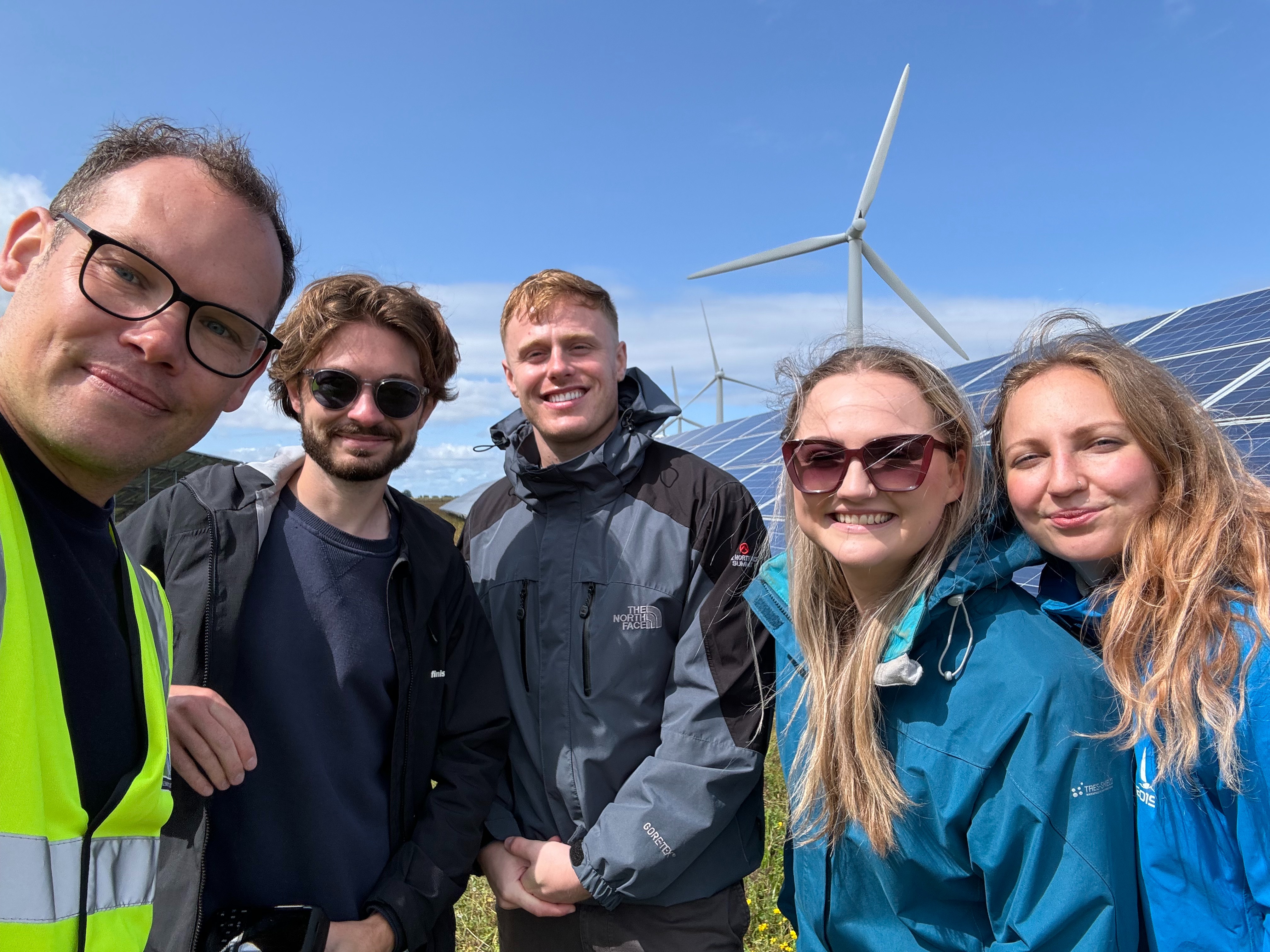 Younity team in a field while a site visit to Westmill Energy.