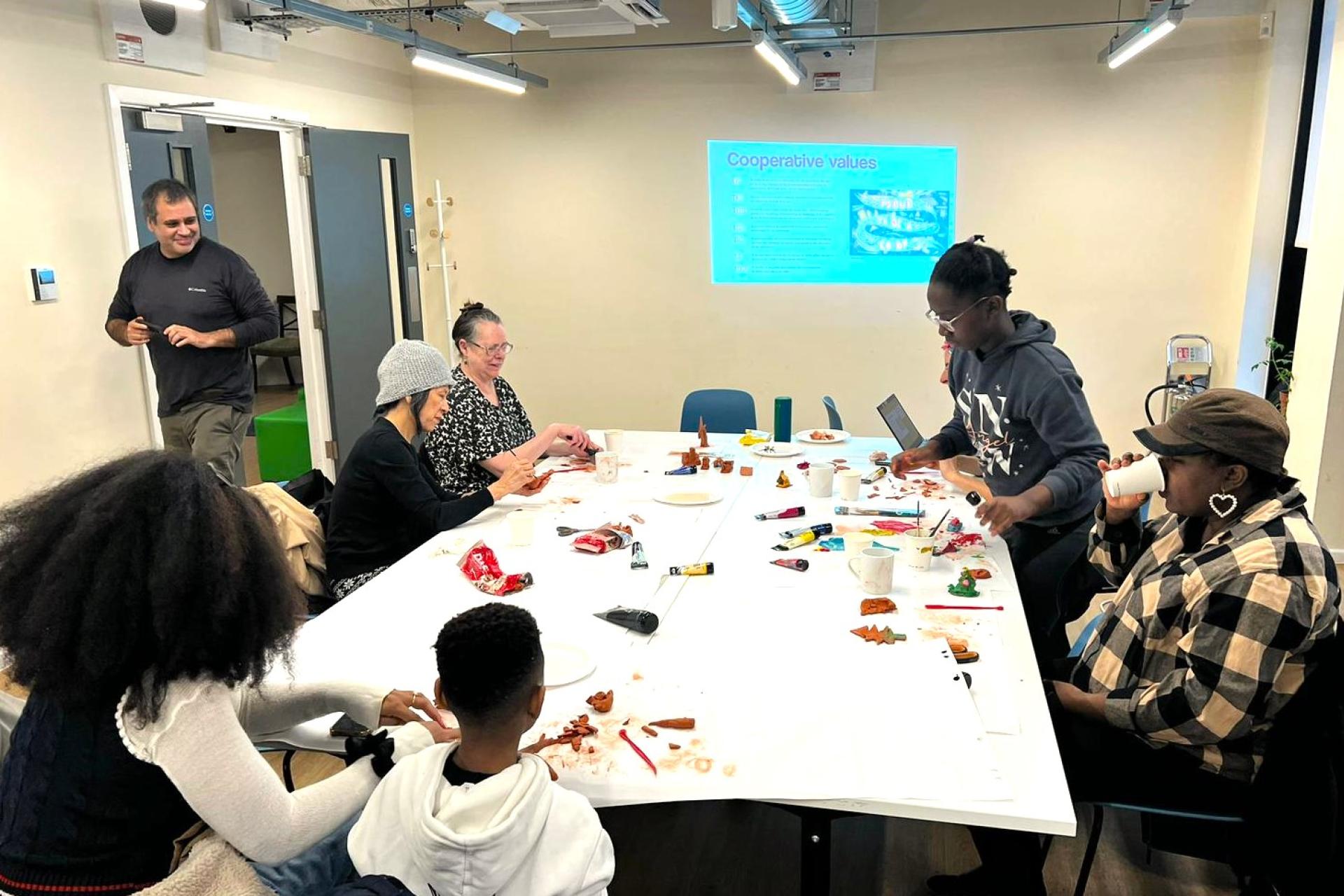 A group participating in an art workshop in a bright classroom.