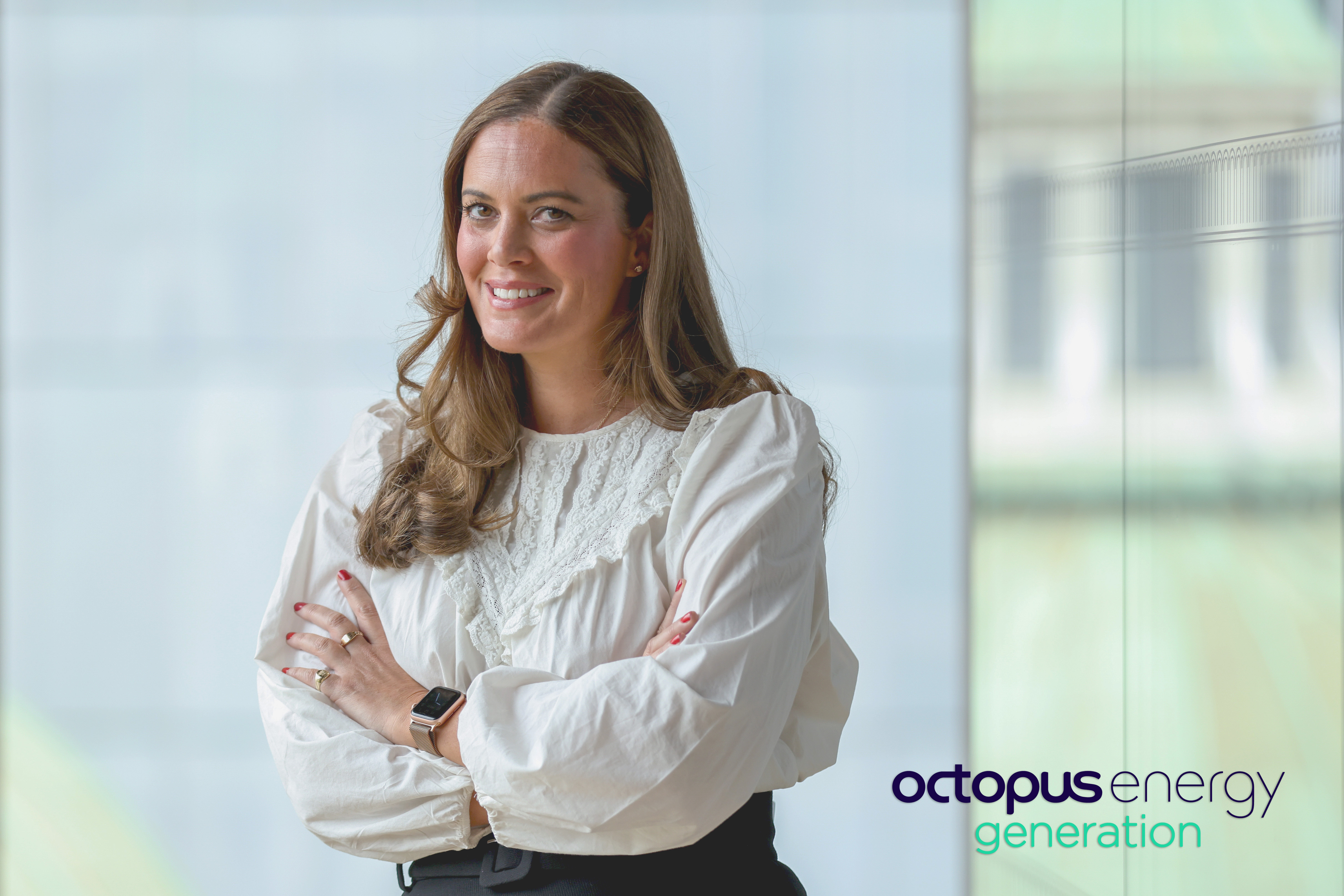 Zoisa North-Bond, Octopus Energy Generation CEO, smiling in a glass office.