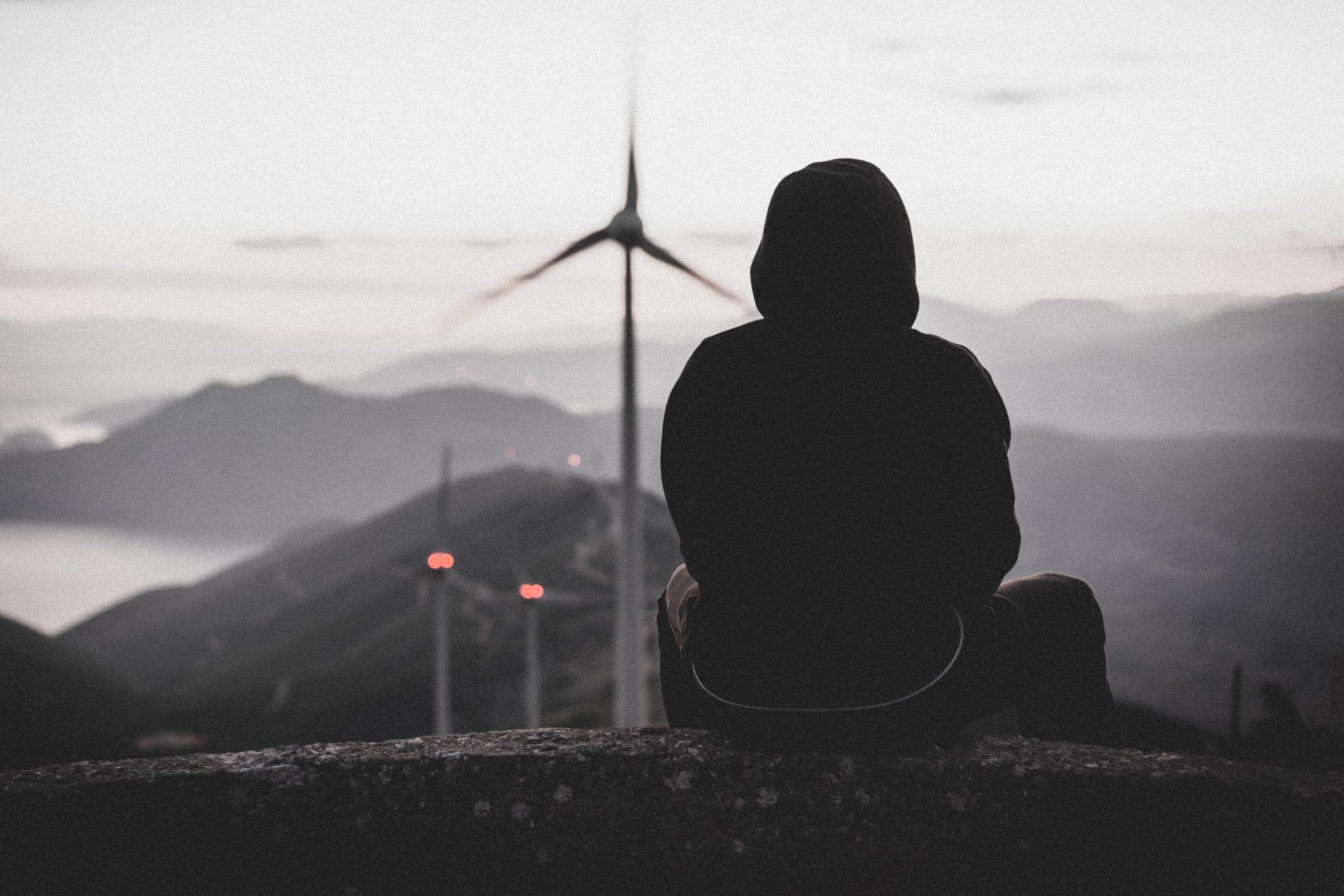 Person and overview of turbine in moody settings