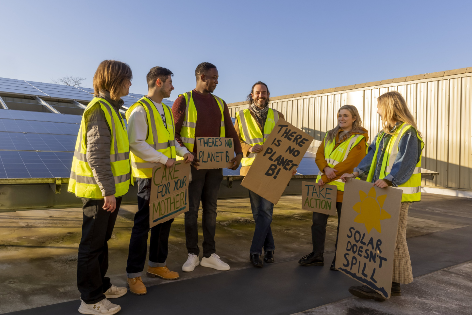 Volunteers stood in front of solar panels