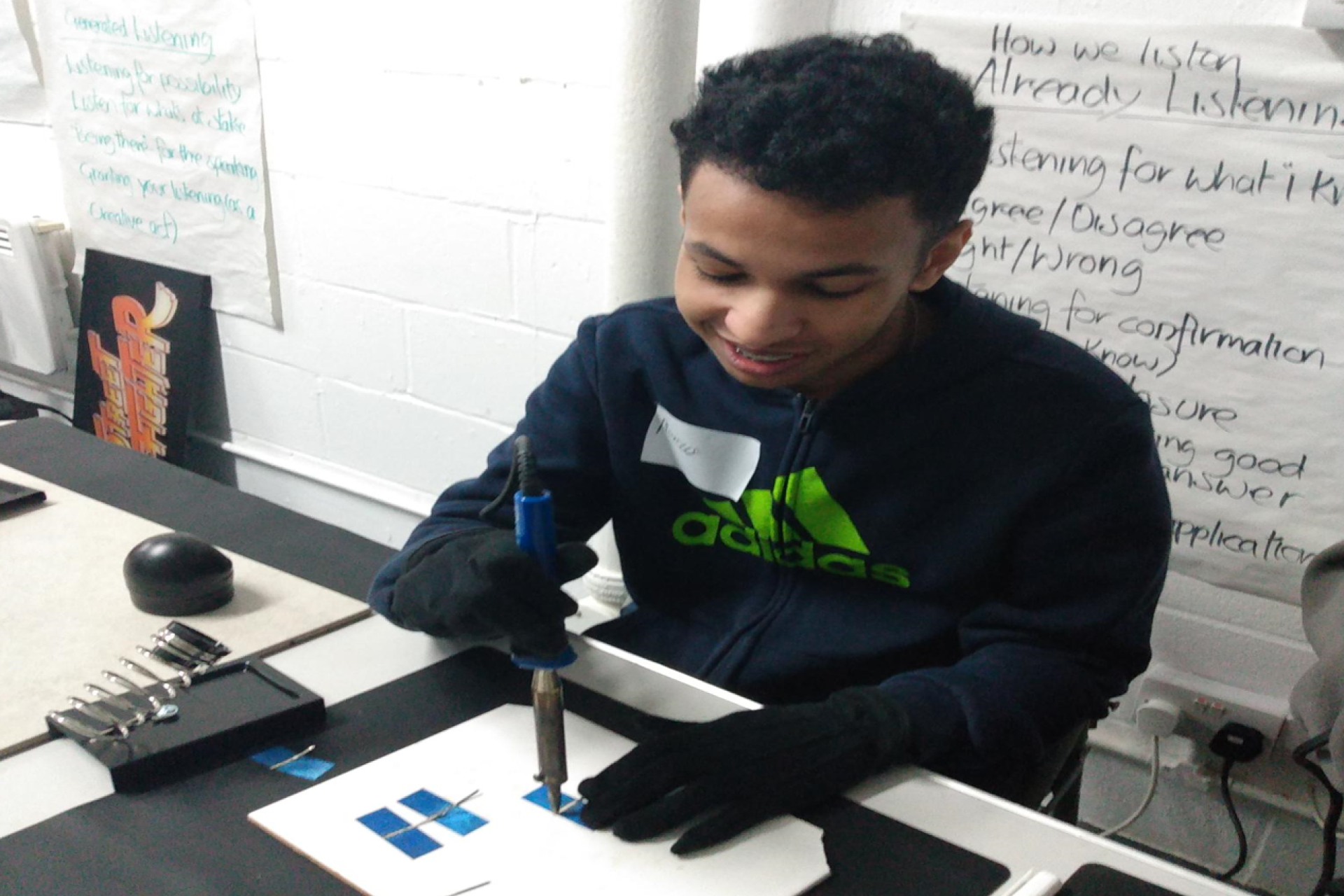 A student assembling a solar panel during a workshop.