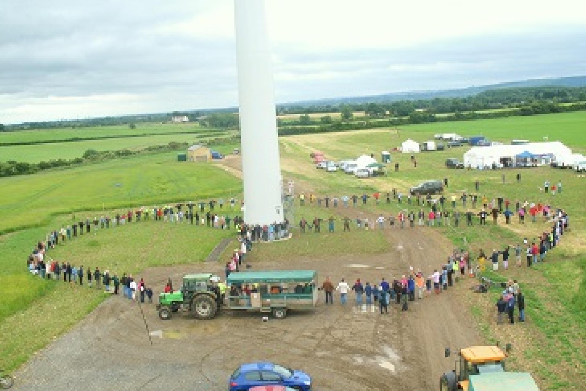 Members of Westmill Wind Co-operative gathered near one of their turbines.