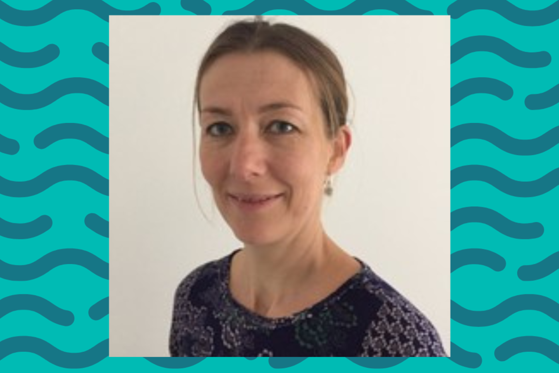 Laura Wilson headshot in front of a blue background 