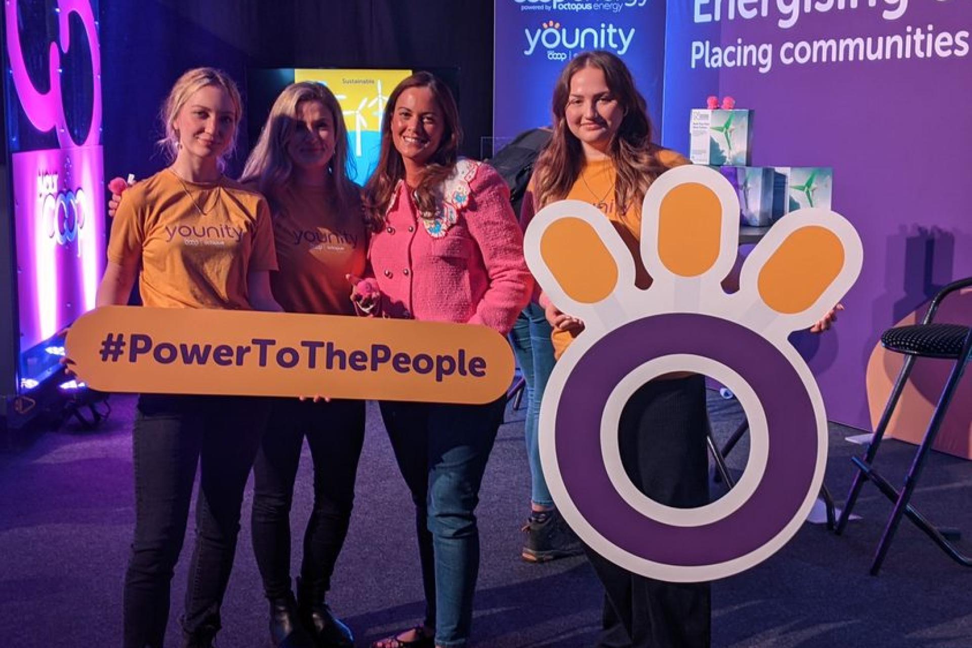 The Younity team posing with board member Zoisa  at an event.