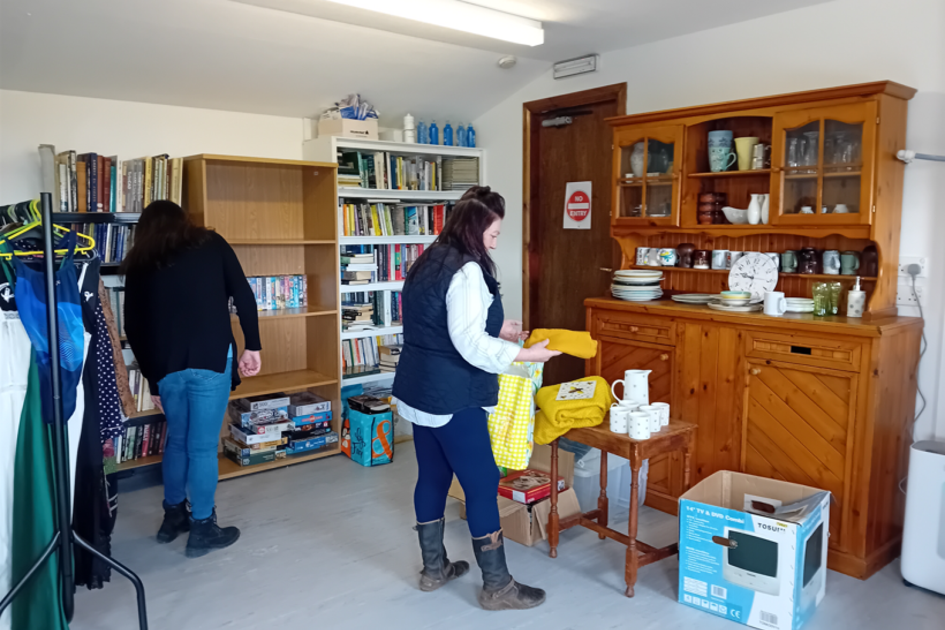 Island residents browsing the Sharing Shed for useful pre-loved items to reuse and re-purpose.