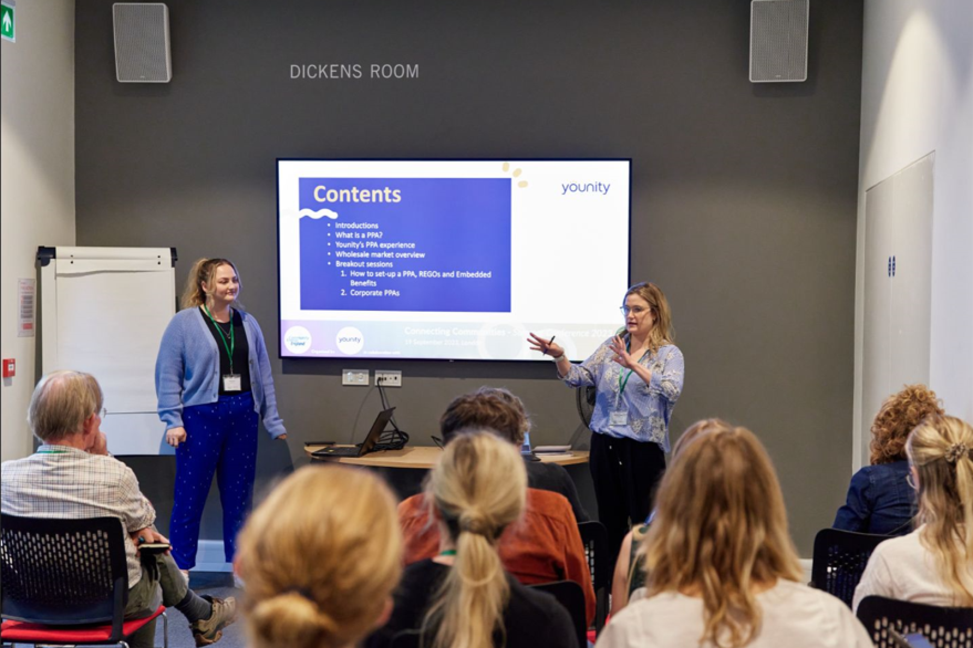 Michaela and Connie presenting a talk on Power Purchase Agreements at a community energy event.