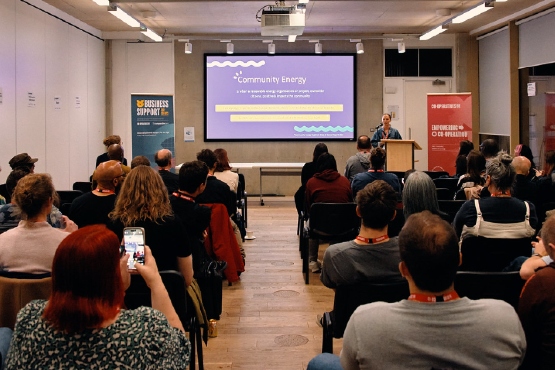 The Younity team presenting to a packed audience, engaging and sharing insights.