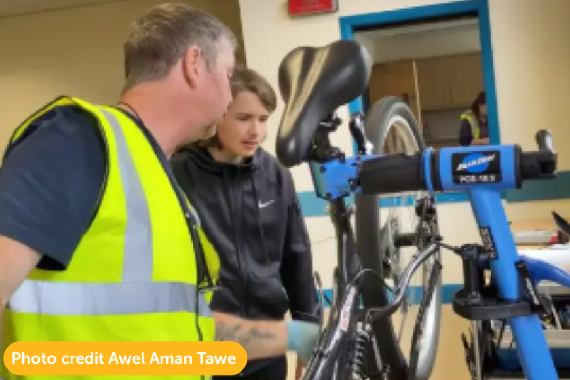 Awel Aman Tawe running a repair workshop.