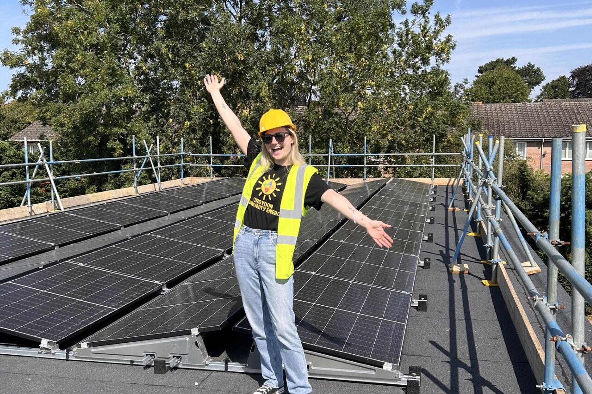 Connie stood in front of solar panels.