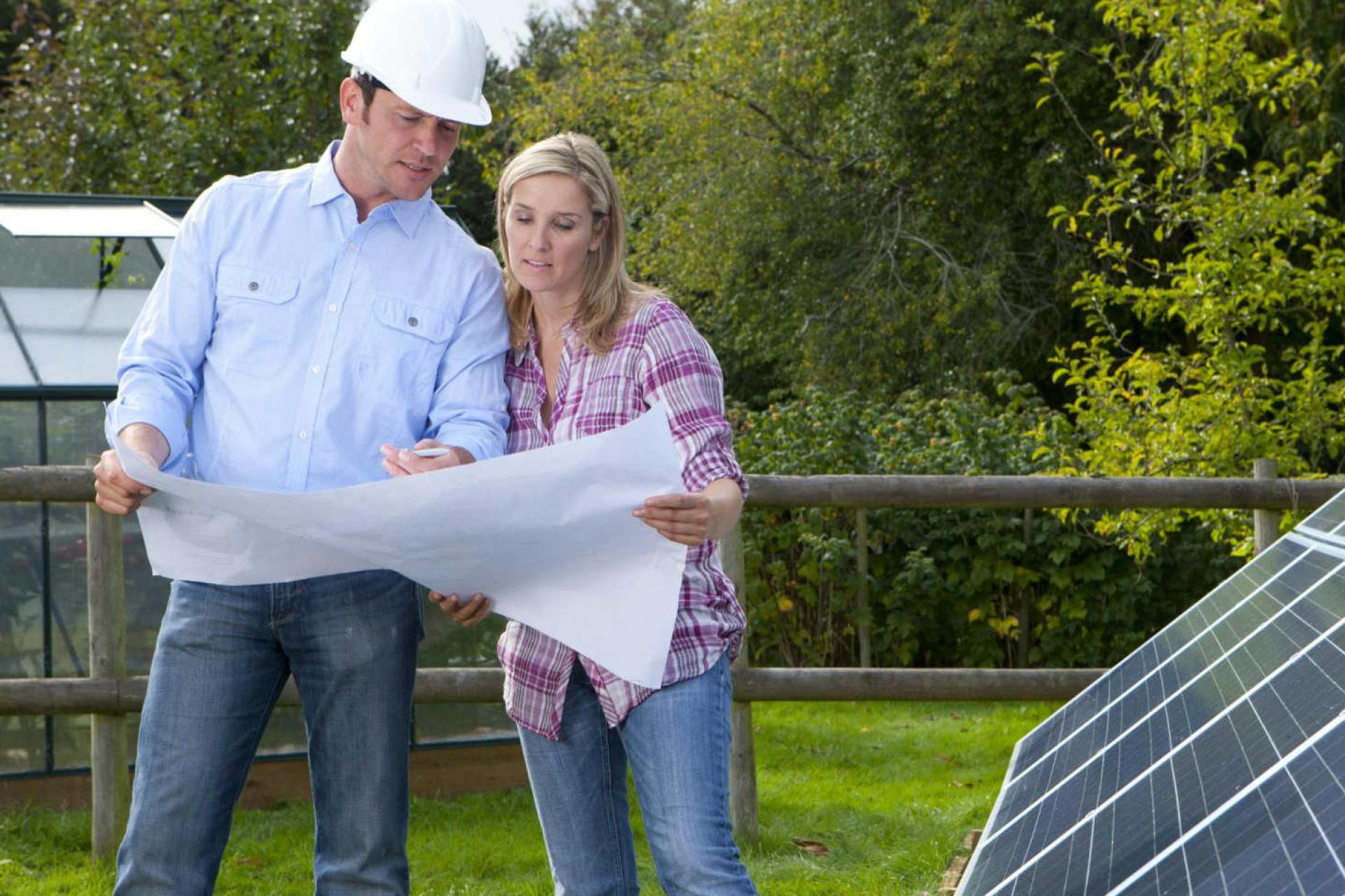 Engineers performing maintenance on solar panels.