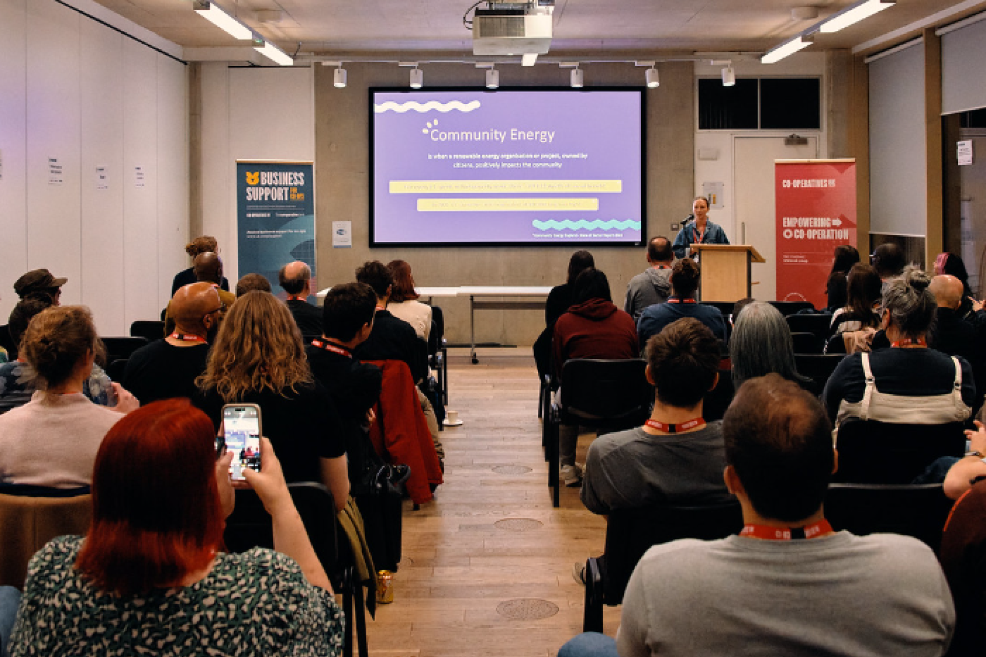 The Younity team addressing a large audience during a workshop.