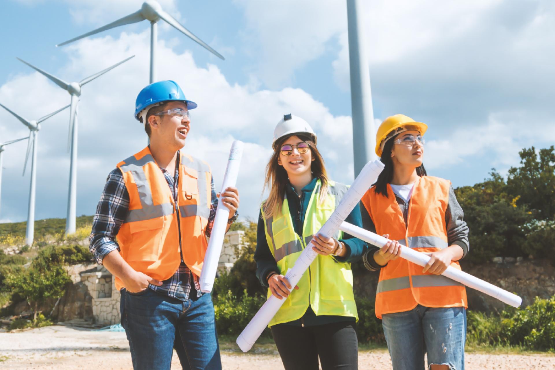 Engineers studying project plans at a wind farm.