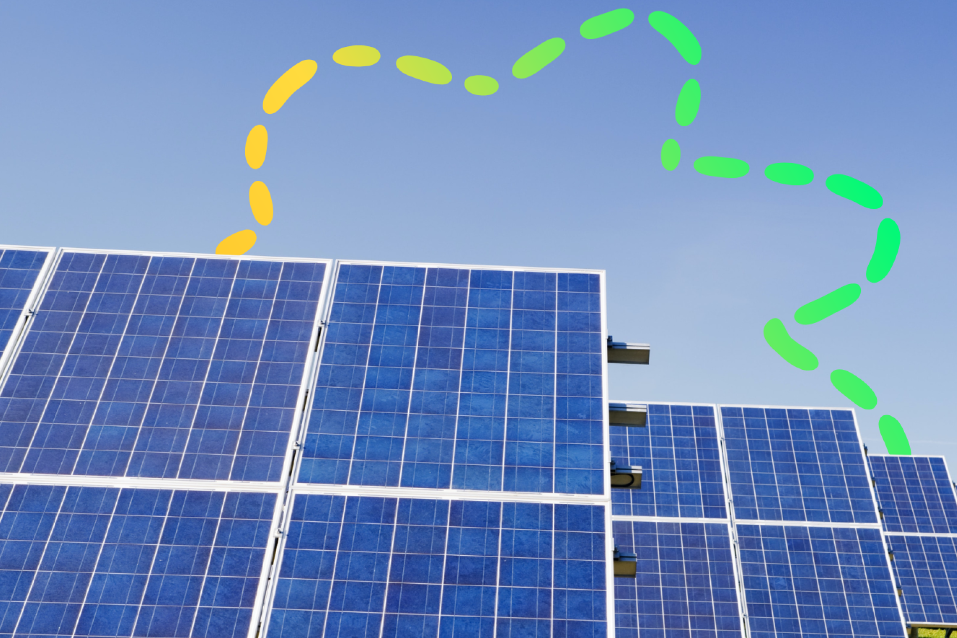 A row of four solar panels on a sunny day, with a Community Power Club banner in the background.