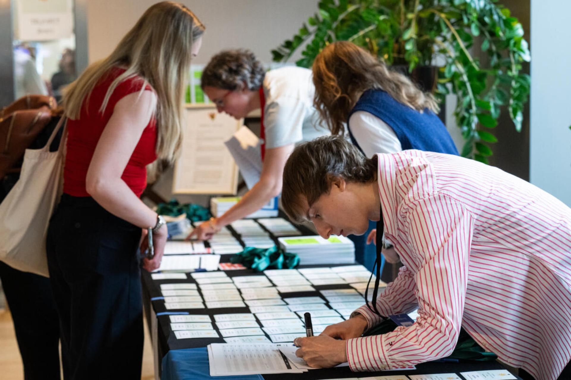 Event attendees collecting their name cards before the event.