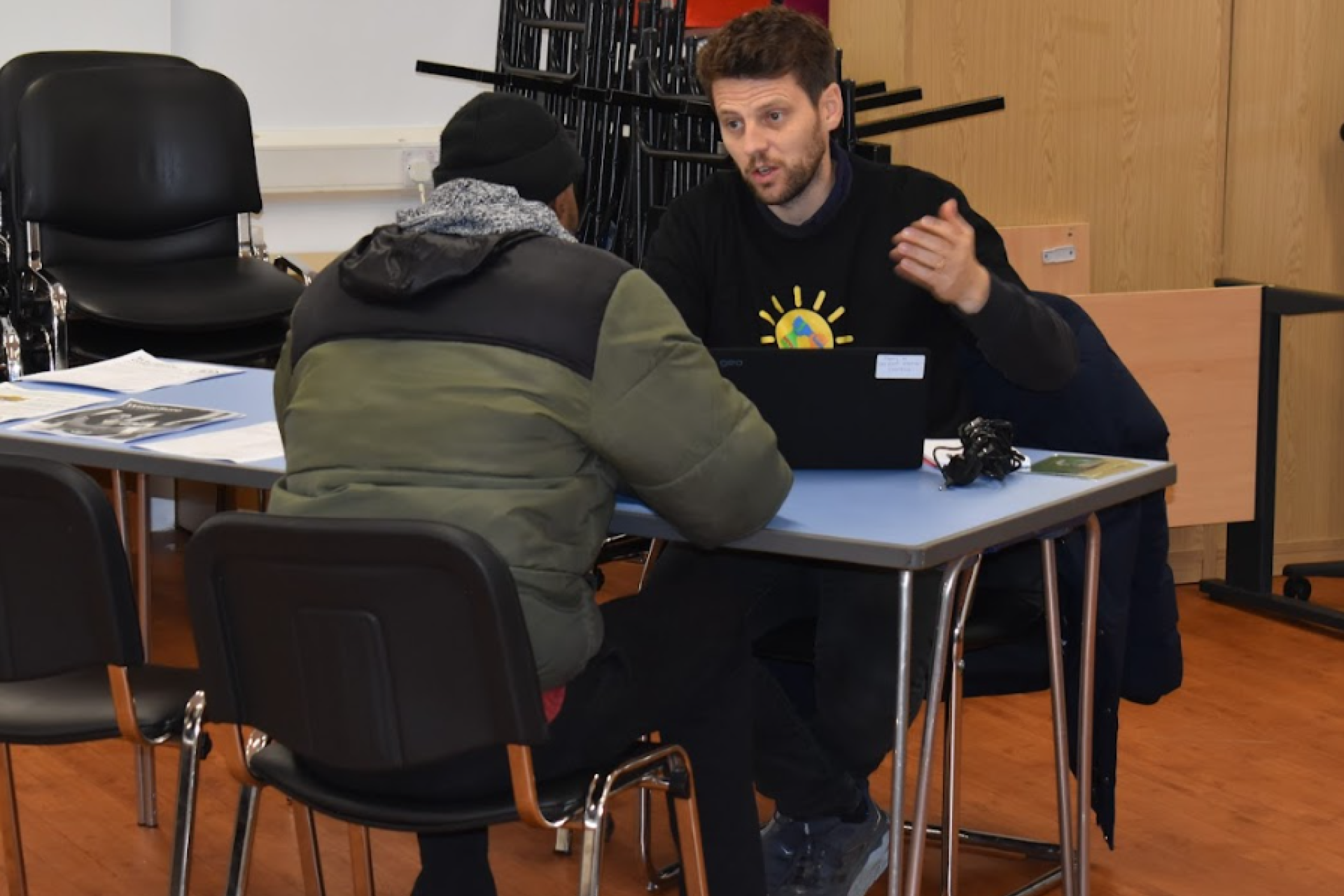 An Energy Champion smiling giving advice to a vulnerable customer.