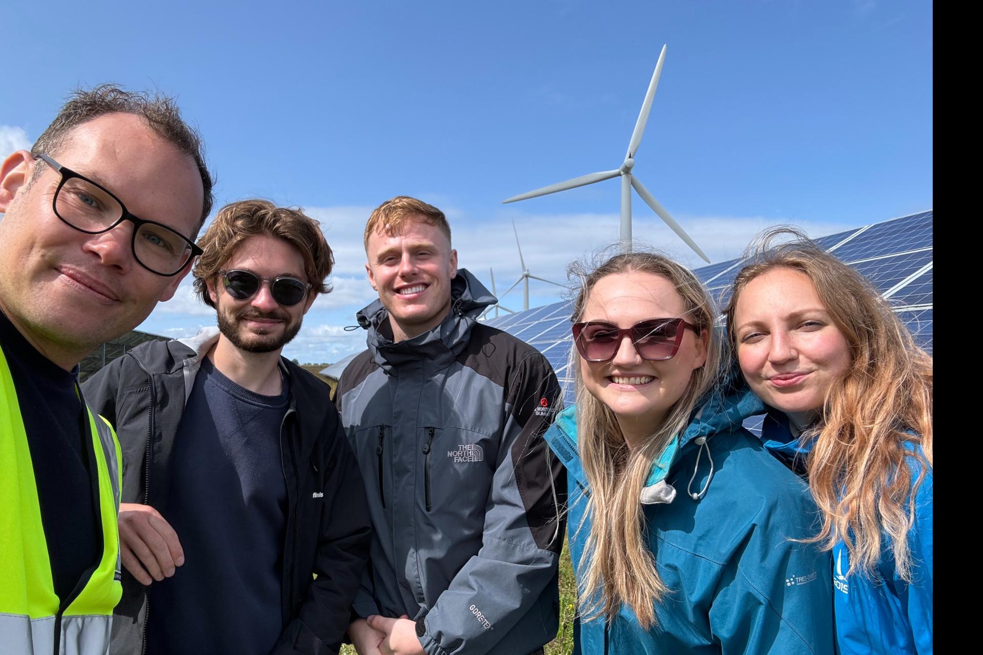 Younity team in a field while a site visit to Westmill Energy.